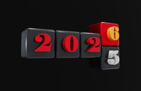 2025と2026の数字が配置された黒背景の立体ブロックデザイン