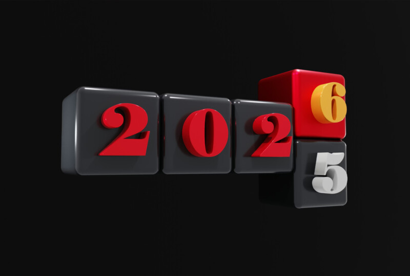 2025と2026の数字が配置された黒背景の立体ブロックデザイン